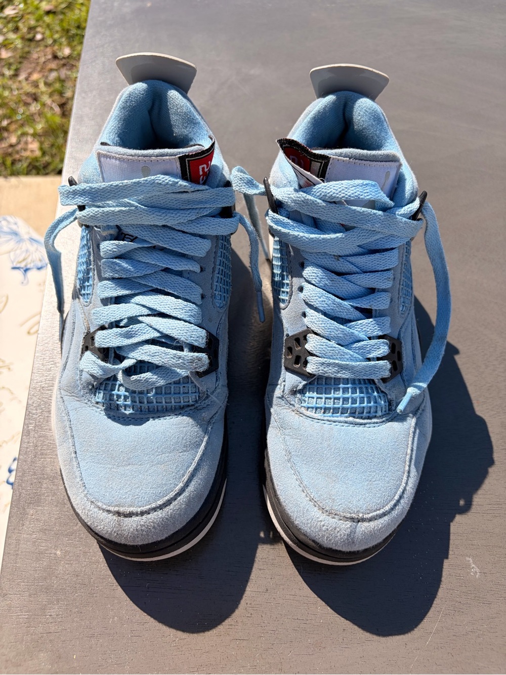 Nike Air Jordan 4 Retro University Blue sneakers.